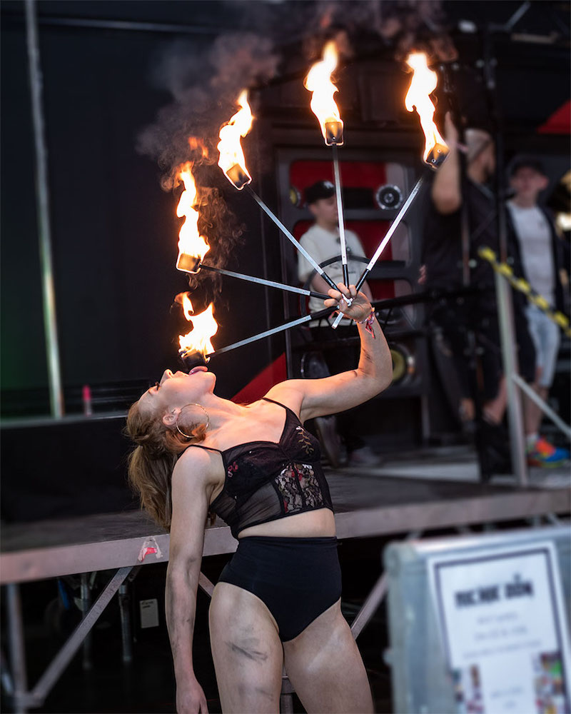 Girl breathing fire on stage